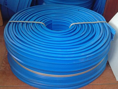 A roll of blue PVC waterstop is on the ground.