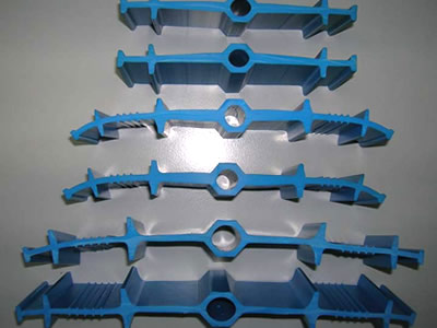 Many pieces of blue ribbed with center bulb PVC waterstops are on the ground.